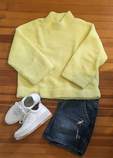 yellow mock neck teddy sweater with jean skirt and white sneakers